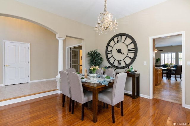 dining area featuring light hardwood / wood-style floors, ceiling fan, and ornate columns