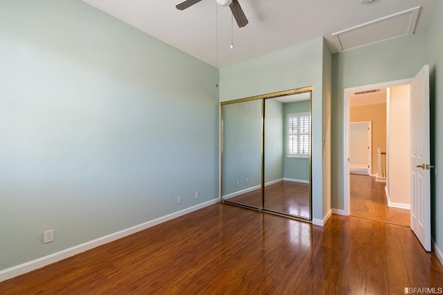 unfurnished bedroom with hardwood / wood-style floors, a closet, and ceiling fan