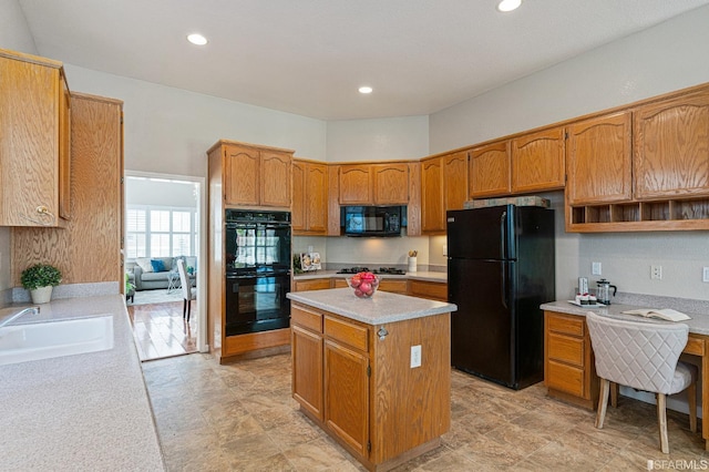 kitchen featuring a center island, sink, and black appliances