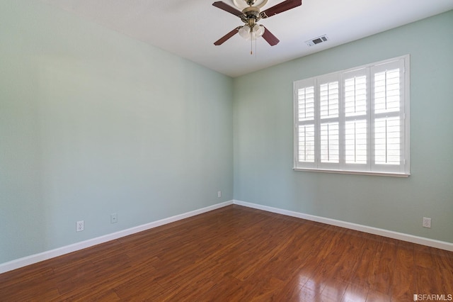 unfurnished room with dark wood-type flooring and ceiling fan