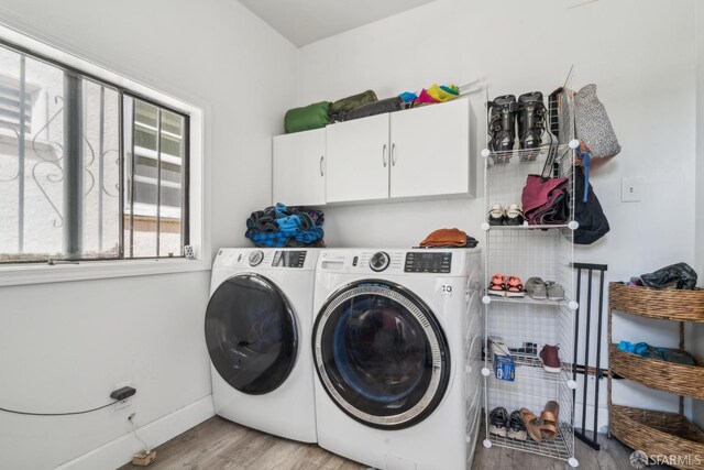 488 41st St, Oakland, CA 94609 - washroom featuring cabinet space, washing machine and clothes dryer, light wood-style floors, and baseboards