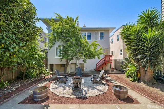 488 41st St, Oakland, CA 94609 - back of property featuring stucco siding, a patio, and stairway
