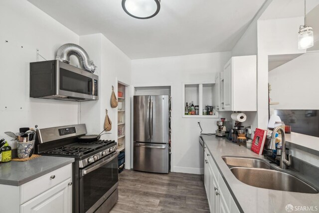 488 41st St, Oakland, CA 94609 - kitchen featuring stainless steel appliances, a sink, white cabinetry, and dark wood-style floors