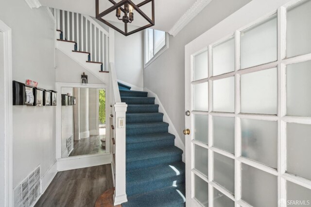 488 41st St, Oakland, CA 94609 - staircase with a chandelier, wood finished floors, healthy amount of natural light, and baseboards