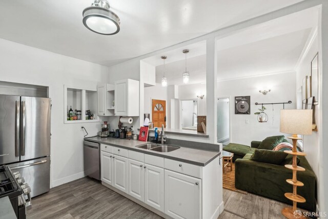 488 41st St, Oakland, CA 94609 - kitchen with appliances with stainless steel finishes, a sink, light wood-style flooring, and white cabinets