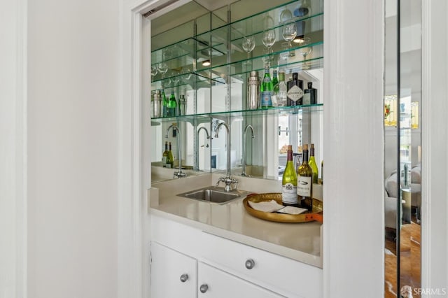 bar featuring indoor wet bar and a sink