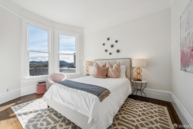 bedroom featuring wood finished floors and baseboards