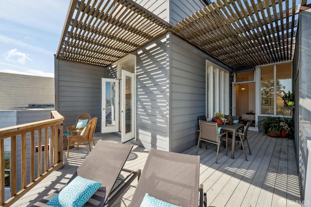 wooden deck featuring outdoor dining area and a pergola