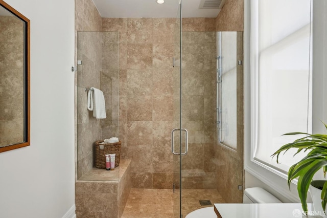 bathroom with vanity, toilet, visible vents, and a stall shower