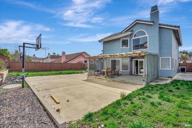 rear view of property featuring central AC and a patio area