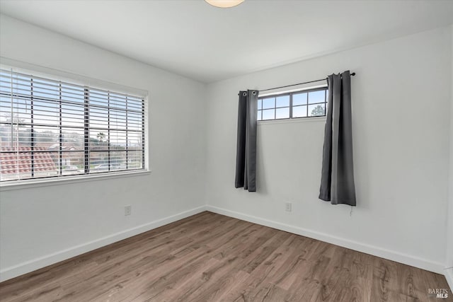 empty room with hardwood / wood-style floors