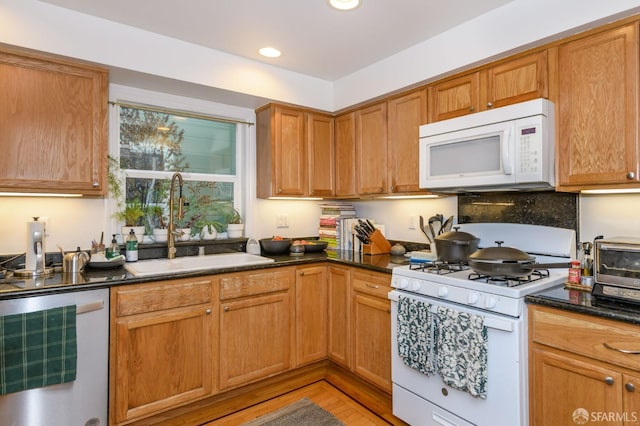 kitchen with sink, beverage cooler, and white appliances