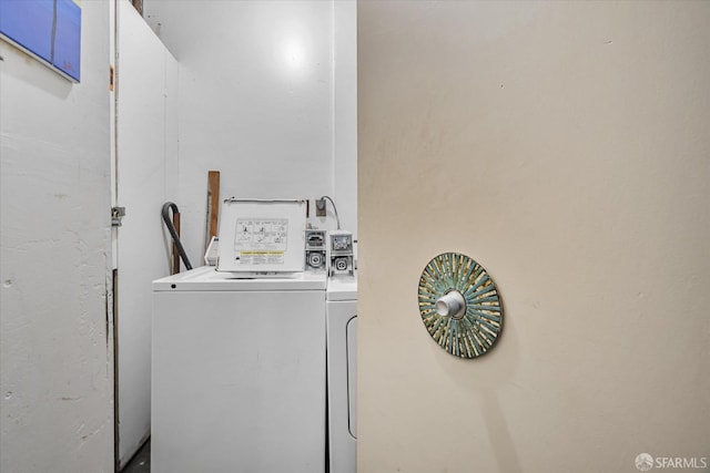 clothes washing area with washer and clothes dryer