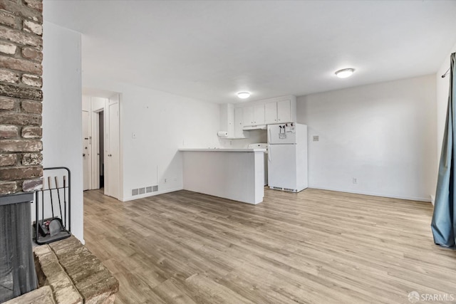 unfurnished living room with light hardwood / wood-style flooring