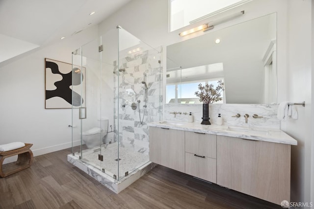 bathroom featuring a shower with door, wood-type flooring, toilet, and vanity