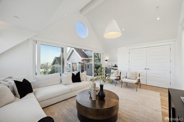 living room featuring beam ceiling, wood-type flooring, and high vaulted ceiling