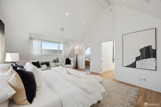 bedroom with high vaulted ceiling, light hardwood / wood-style flooring, and beamed ceiling