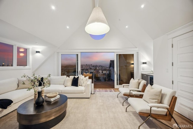 living room featuring high vaulted ceiling and hardwood / wood-style flooring