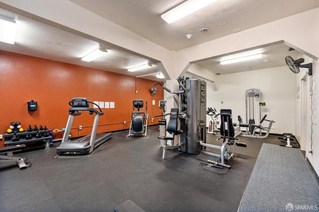 gym with a textured ceiling