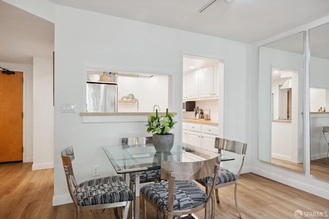 dining area with light wood-type flooring