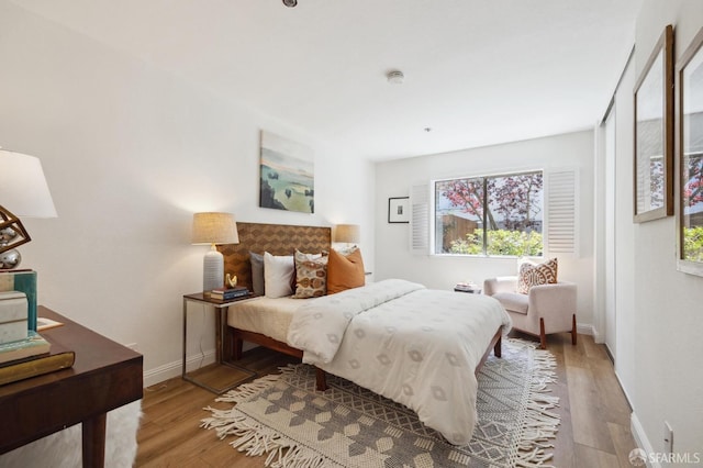 bedroom with hardwood / wood-style flooring