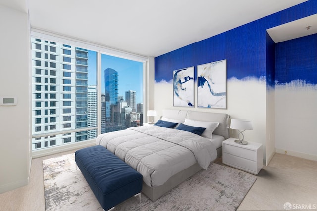 401 Harrison St Unit 23C, San Francisco, CA 94105 - bedroom with expansive windows, multiple windows, a skyline view, and carpet