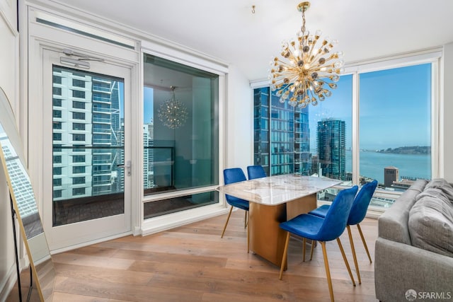 401 Harrison St Unit 23C, San Francisco, CA 94105 - dining area with a chandelier, floor to ceiling windows, and light wood-type flooring
