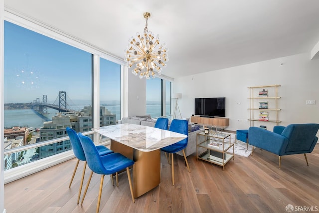 401 Harrison St Unit 23C, San Francisco, CA 94105 - dining room with a chandelier, wood finished floors, a water view, and expansive windows