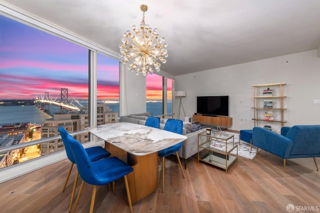 401 Harrison St Unit 23C, San Francisco, CA 94105 - dining area featuring a chandelier, wood finished floors, a water view, and a wall of windows