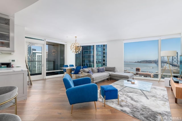 401 Harrison St Unit 23C, San Francisco, CA 94105 - living room with floor to ceiling windows, a chandelier, wood finished floors, and a water view