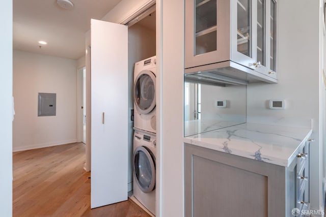 401 Harrison St Unit 23C, San Francisco, CA 94105 - laundry room featuring stacked washer / drying machine, electric panel, light wood-type flooring, and recessed lighting
