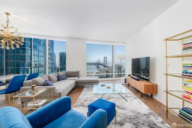 401 Harrison St Unit 23C, San Francisco, CA 94105 - living area featuring expansive windows, a chandelier, and wood finished floors