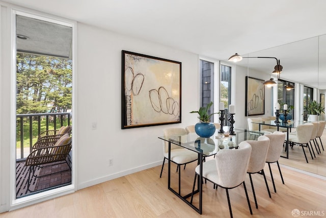 dining area with healthy amount of natural light, wood finished floors, and baseboards