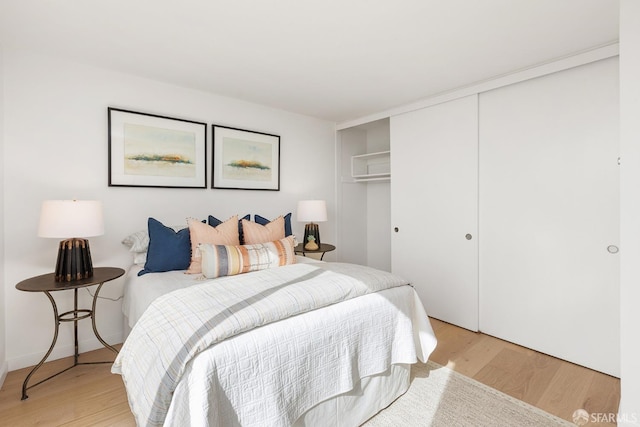 bedroom featuring light wood-type flooring and a closet
