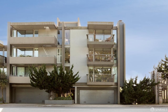 view of apartment building / complex featuring a garage
