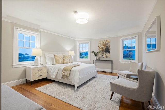 bedroom featuring baseboards, dark wood-type flooring, and ornamental molding