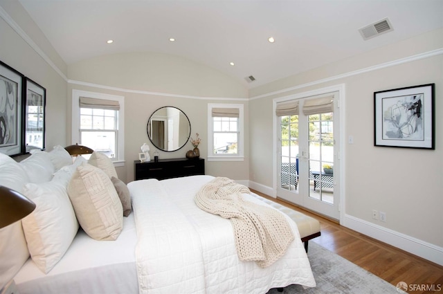 bedroom with access to exterior, visible vents, baseboards, lofted ceiling, and wood finished floors