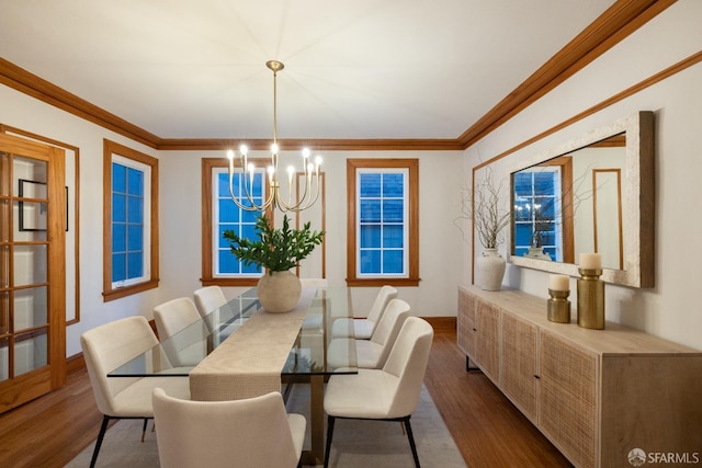 dining space featuring dark wood-type flooring, a chandelier, and crown molding