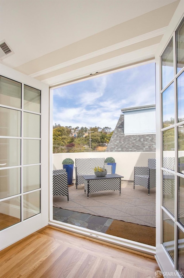 unfurnished sunroom with visible vents