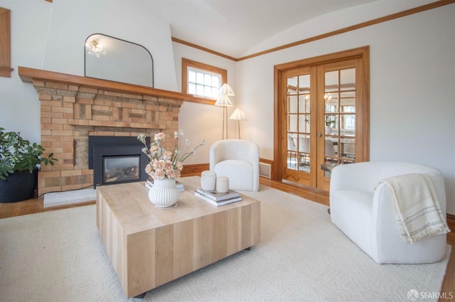 living room with french doors, visible vents, a fireplace, and vaulted ceiling