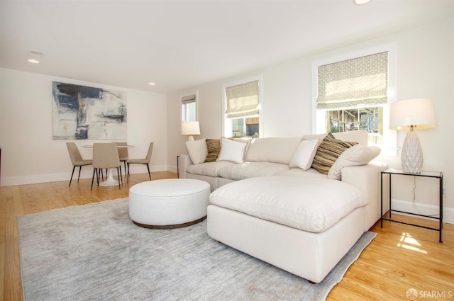 living area with recessed lighting, wood finished floors, and baseboards