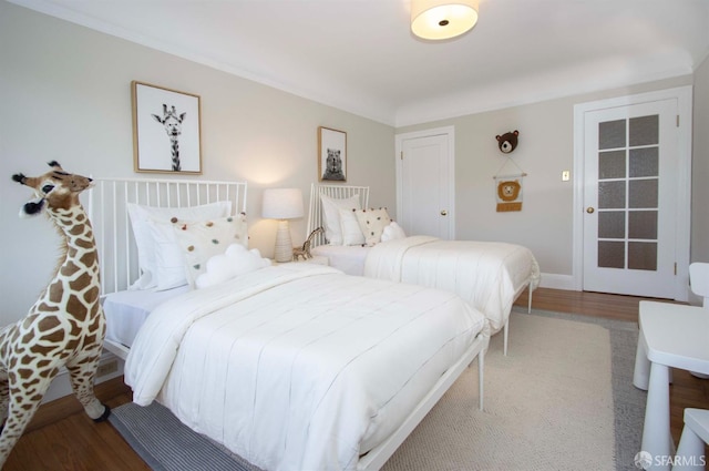 bedroom featuring baseboards and wood finished floors