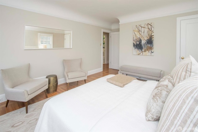 bedroom with baseboards and wood finished floors