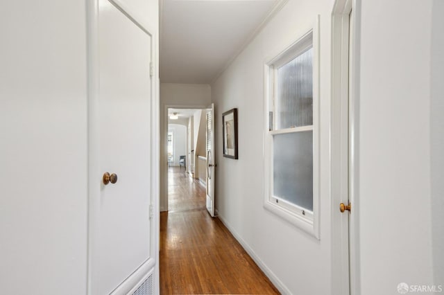 hall featuring ornamental molding and wood-type flooring