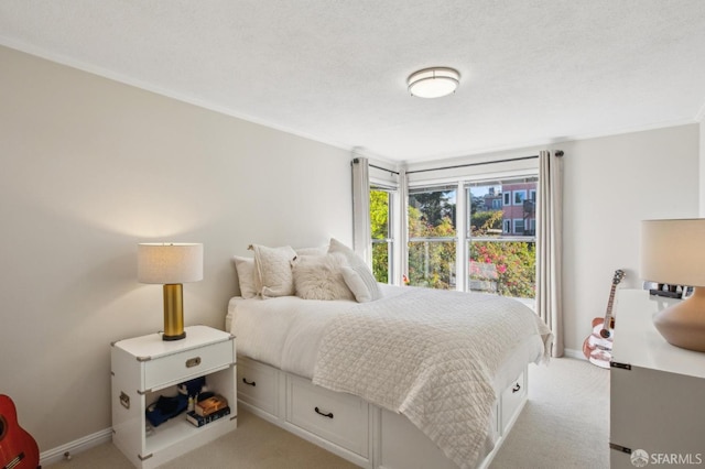 bedroom with light colored carpet and a textured ceiling