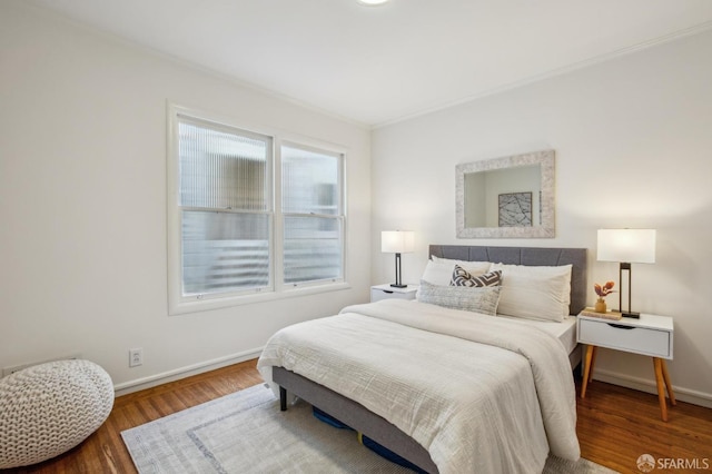 bedroom featuring hardwood / wood-style floors and crown molding