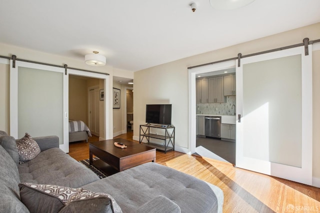 living room featuring wood-type flooring and a barn door