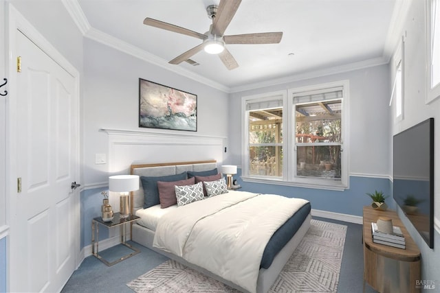 carpeted bedroom with ceiling fan and ornamental molding