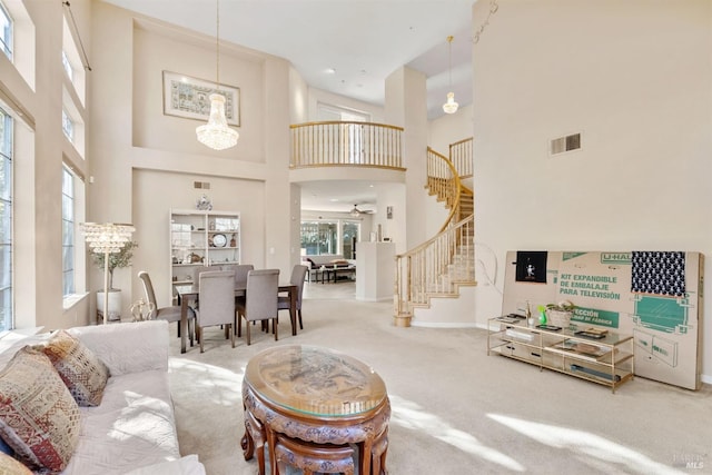 living room with carpet flooring, a high ceiling, and a notable chandelier