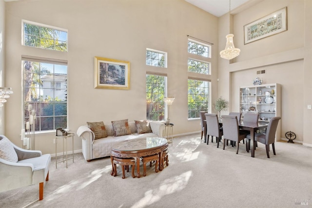 carpeted living room featuring a towering ceiling